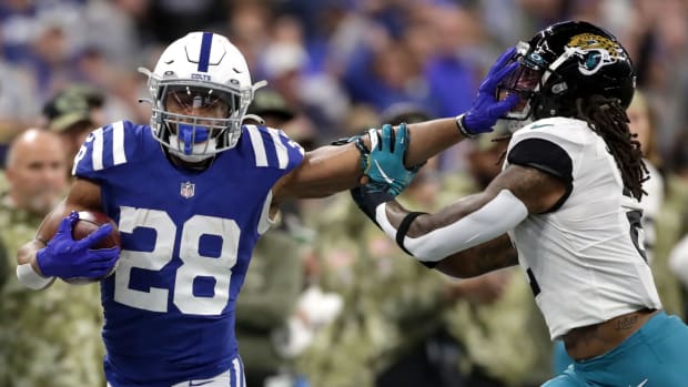 Indianapolis Colts running back Jonathan Taylor (28) still arms Jacksonville Jaguars free safety Rayshawn Jenkins (2) while rushing the ball Sunday, Nov. 14, 2021, during a game against the Jacksonville Jaguars at Lucas Oil Stadium in Indianapolis.